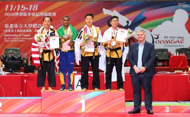 Silver Medalist Master Lee (Left) with three other competitors (Right) during 2018 Taekwondo World Championship in Taipei, Taiwan.